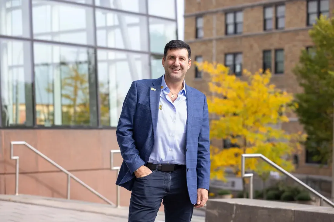 Alumni Aaron Krause the founder of Scrub Daddy standing and smiling outside Whitman School of Management.